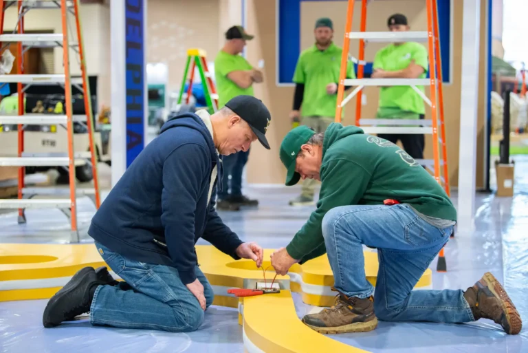 Event crew assembling a colorful branded installation.
