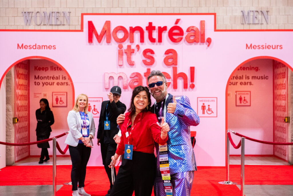 Interactive Montreal-themed photo opportunity with bright red environmental graphics and attendee engagement at PCMA Convening Leaders.