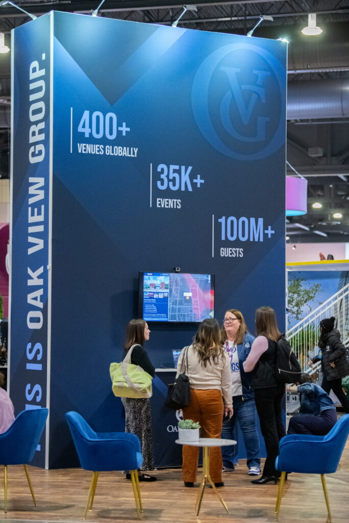 Interactive trade show exhibit with large-format branded graphics and engagement space