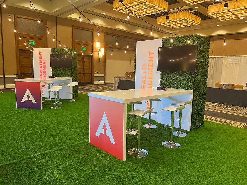 Branded networking space featuring seating, signage, and collaboration areas for conference attendees.
