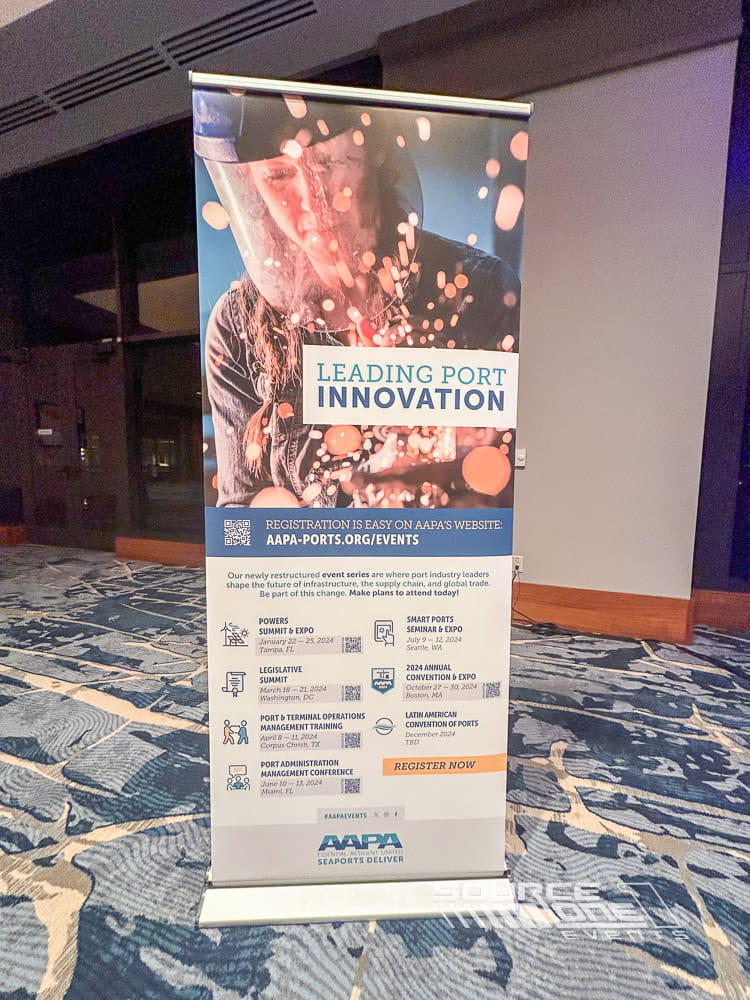 Branded banner stand promoting conference programming and attendee engagement.