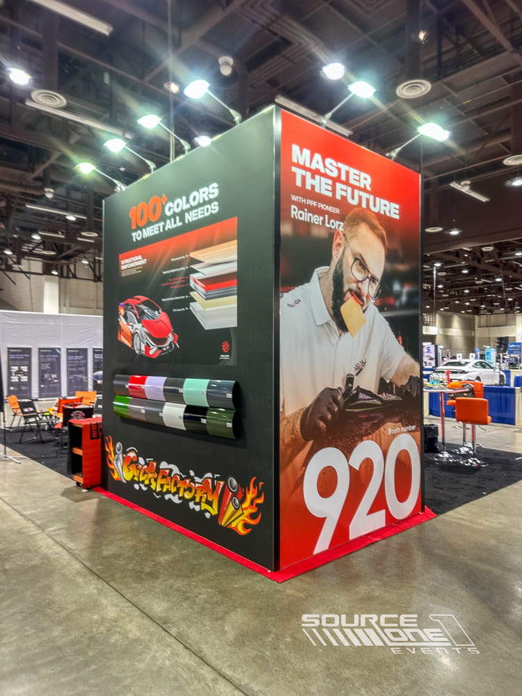 Modern custom exhibit featuring dramatic graphics, digital media, and open collaborative meeting spaces for trade show attendees.