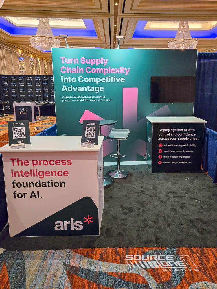 Contemporary hardwall exhibit with colorful branded graphics, digital display, and interactive attendee consultation space.