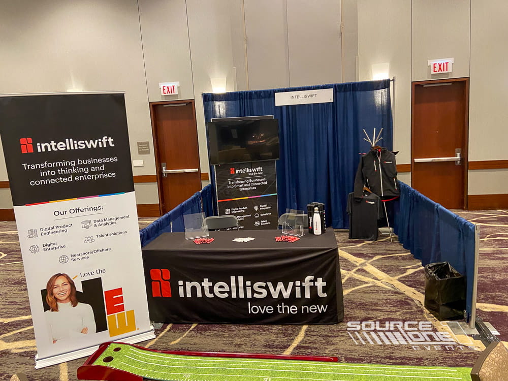 Custom branded IntelliSwift table throw displayed within an exhibit booth for attendee engagement and lead generation.
