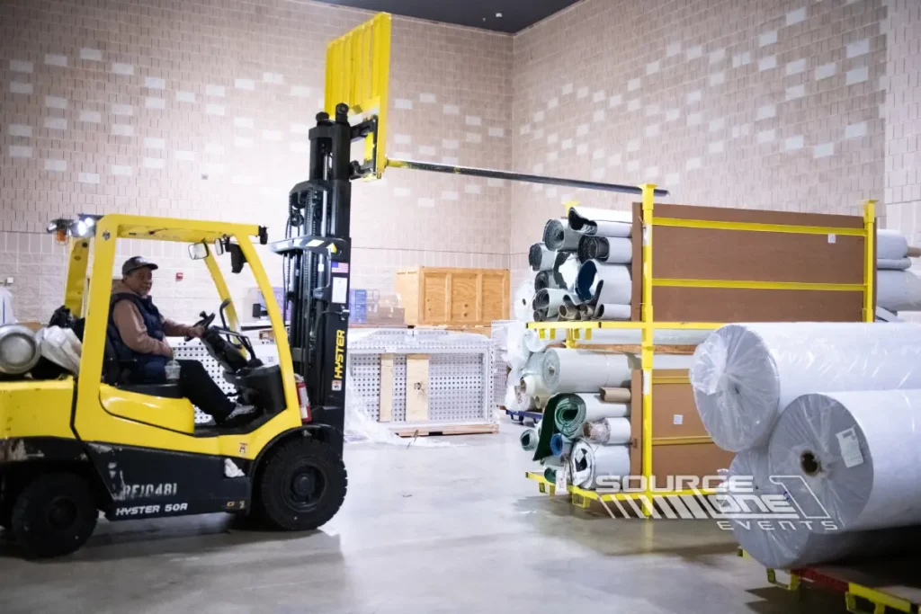 Forklift displayed in a warehouse-style trade show exhibit.