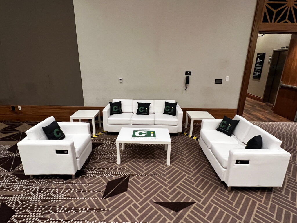 VIP networking lounge with modern furniture rental at corporate conference