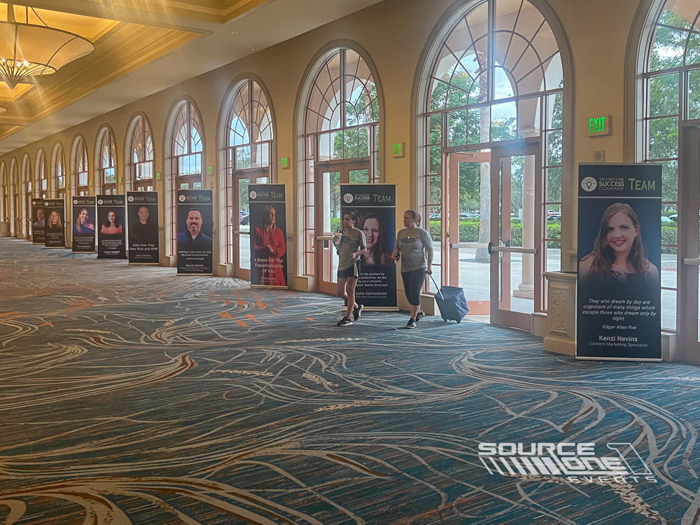 Banner stands displaying event branding inside a conference venue.