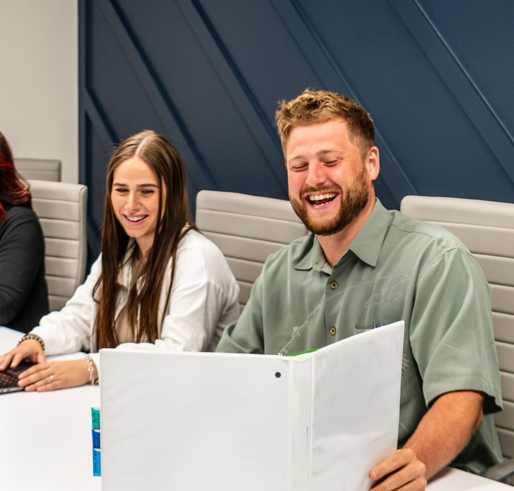 Source One Events staff collaborating during a planning meeting focused on custom exhibit design and event execution.