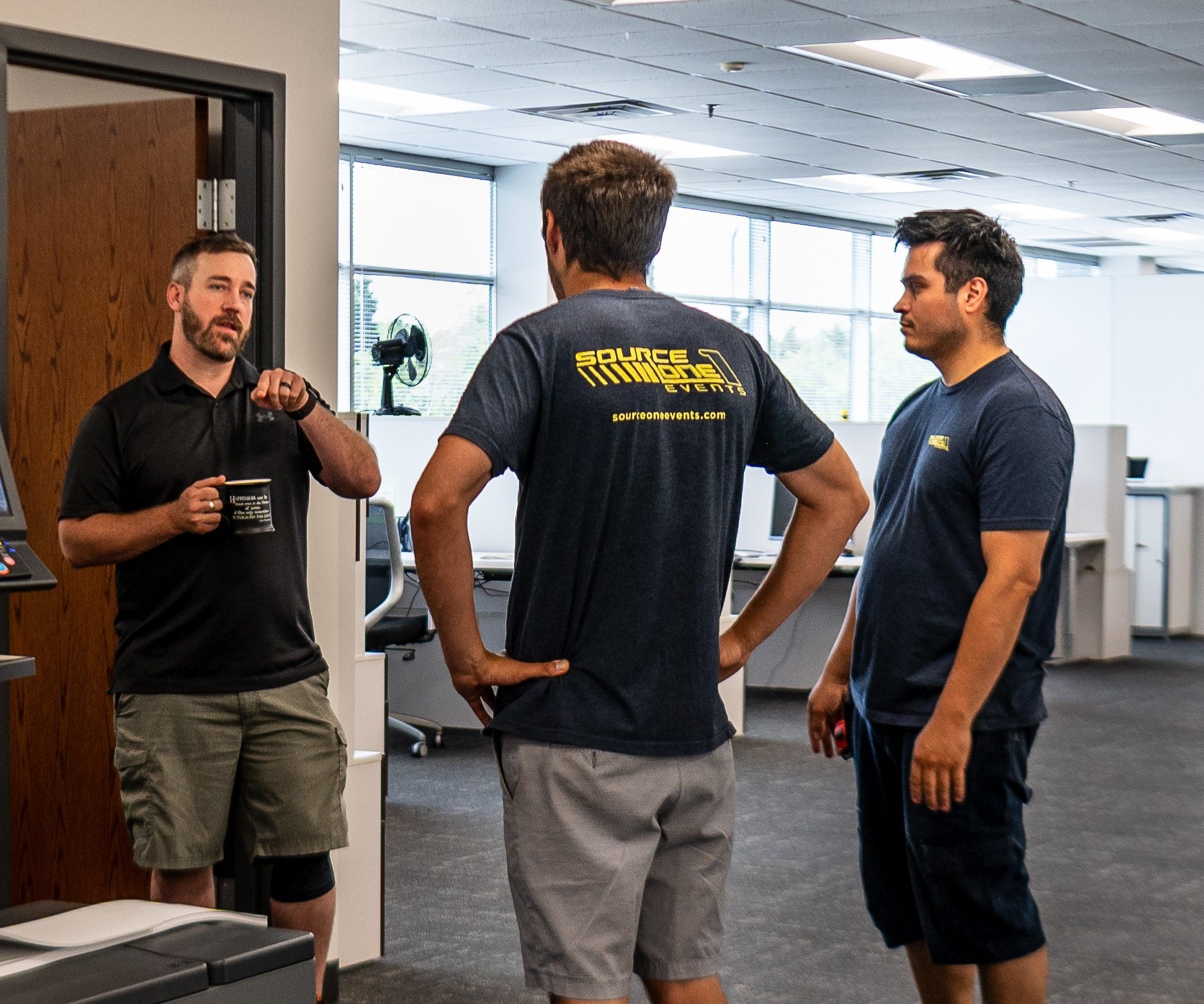 Source One Events production team collaborating on-site during trade show installation and event setup.