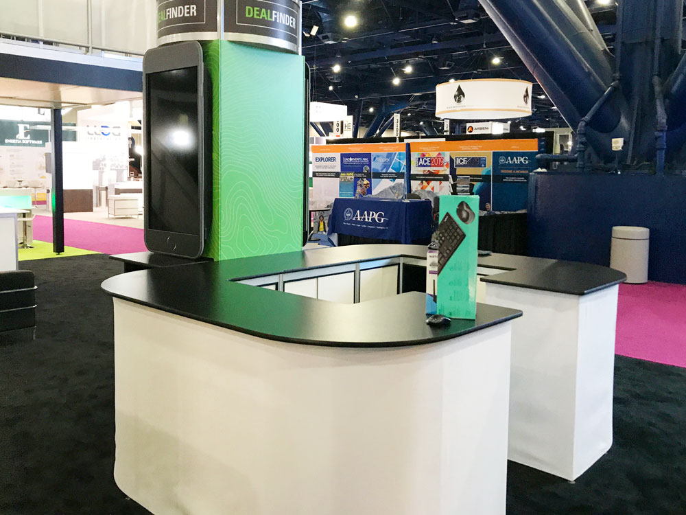 Modern trade show exhibit featuring digital displays and custom branded graphics.