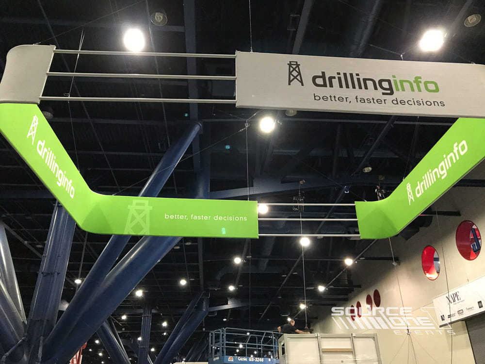 Large suspended exhibit sign featuring Drillinginfo branding, increasing visibility across the trade show floor.