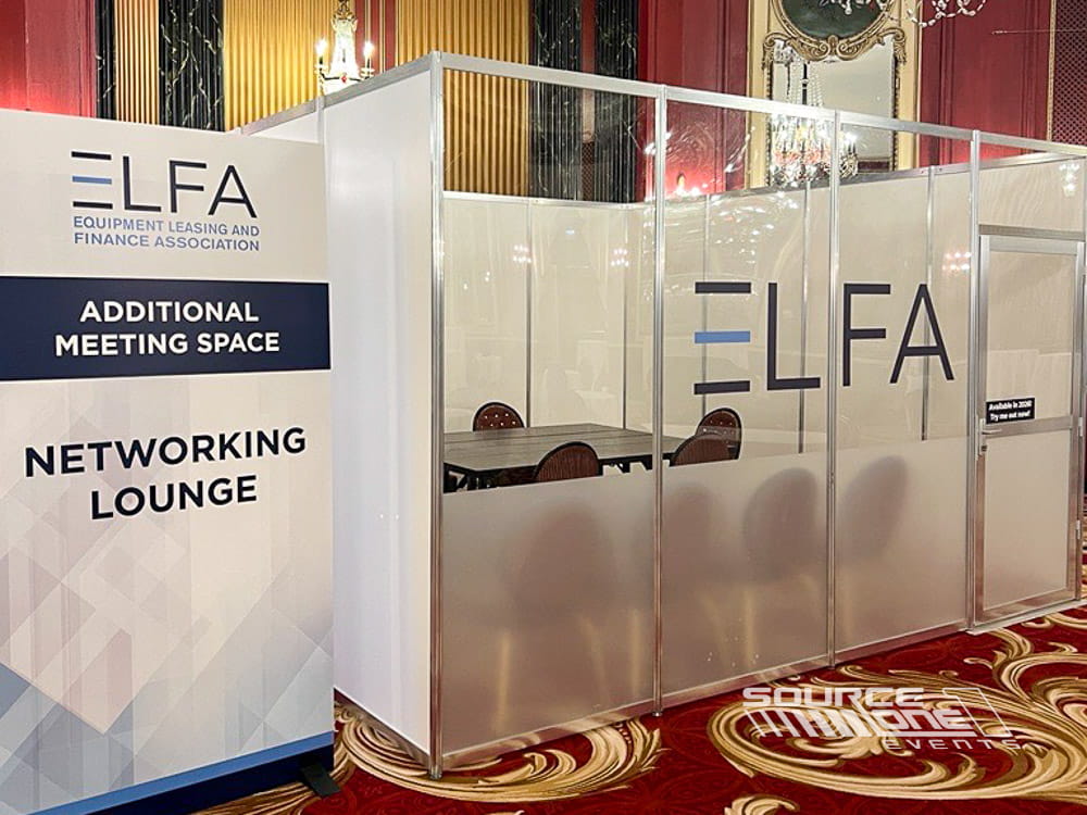 Custom glass-walled meeting room built inside a trade show featuring modern hard-wall construction, transparent panels, and private exhibitor collaboration space.
