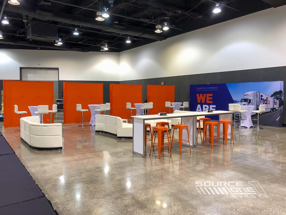 Corporate sales meeting environment featuring branded staging, collaborative seating, and event production elements for internal conferences.