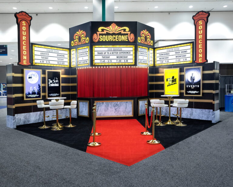 Custom themed trade show entrance featuring vintage marquee signage, red carpet, decorative lighting, and immersive experiential design.