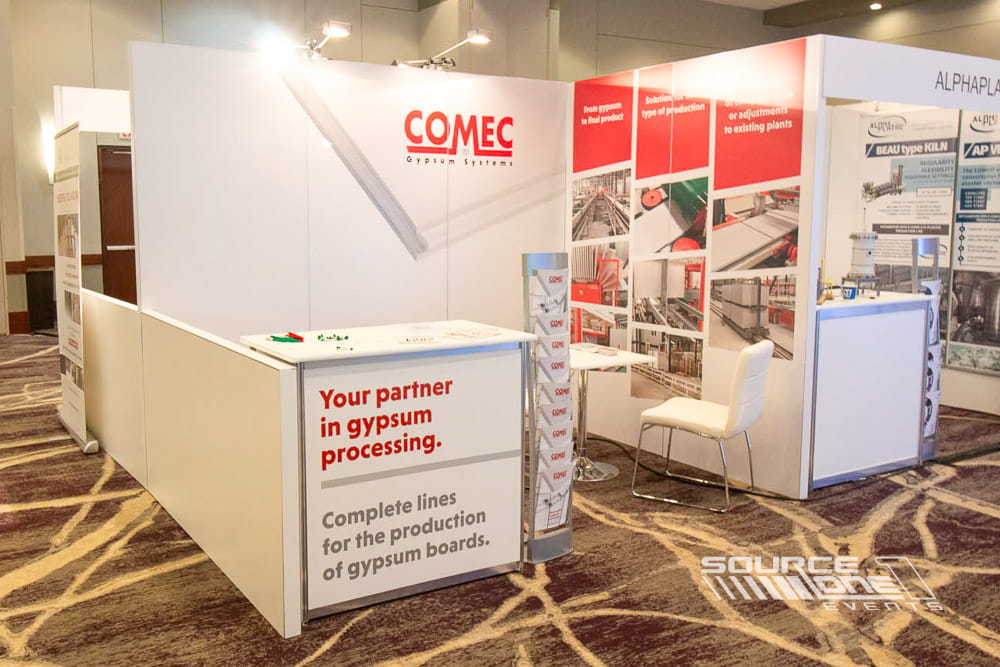 Corporate exhibit showcasing branded graphics, product displays, and custom modular hardwall construction.