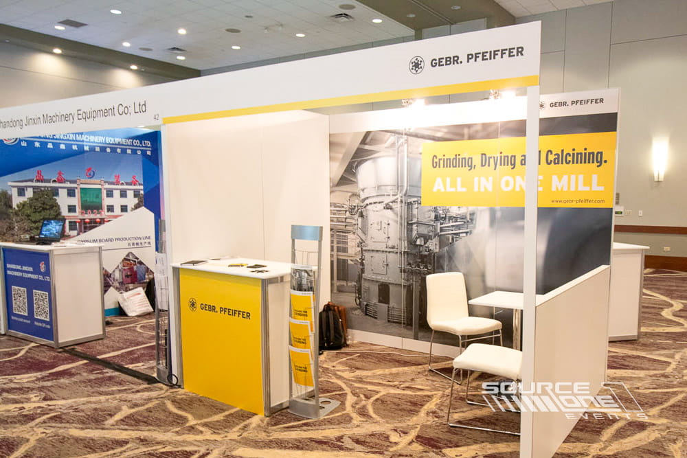 Open hardwall exhibit with clean white finishes, product messaging, and welcoming visitor experience.