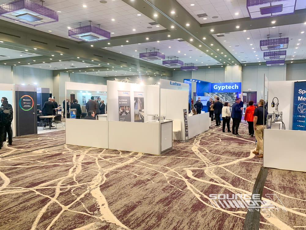 Professional trade show booth with integrated product displays, digital branding, and contemporary exhibit design.