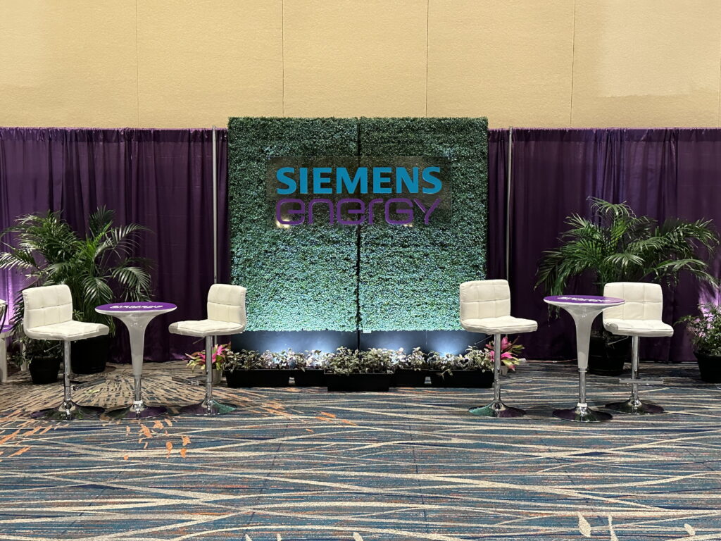 Siemens conference lounge with custom stage backdrop and hospitality seating