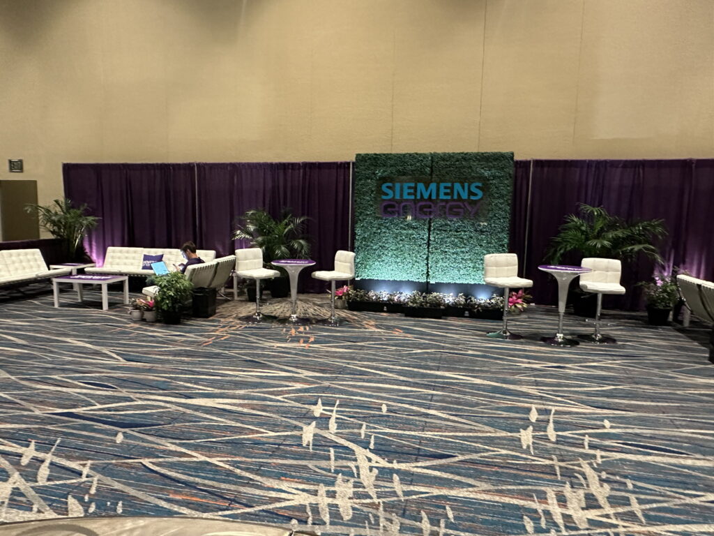 Branded corporate event backdrop and lounge area for attendee engagement