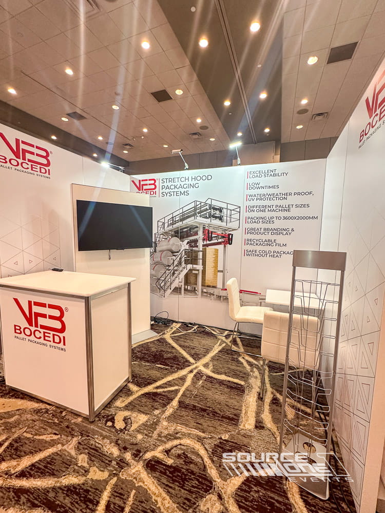 Bright custom exhibit showcasing informational graphics, modular hardwall construction, and attendee interaction space.