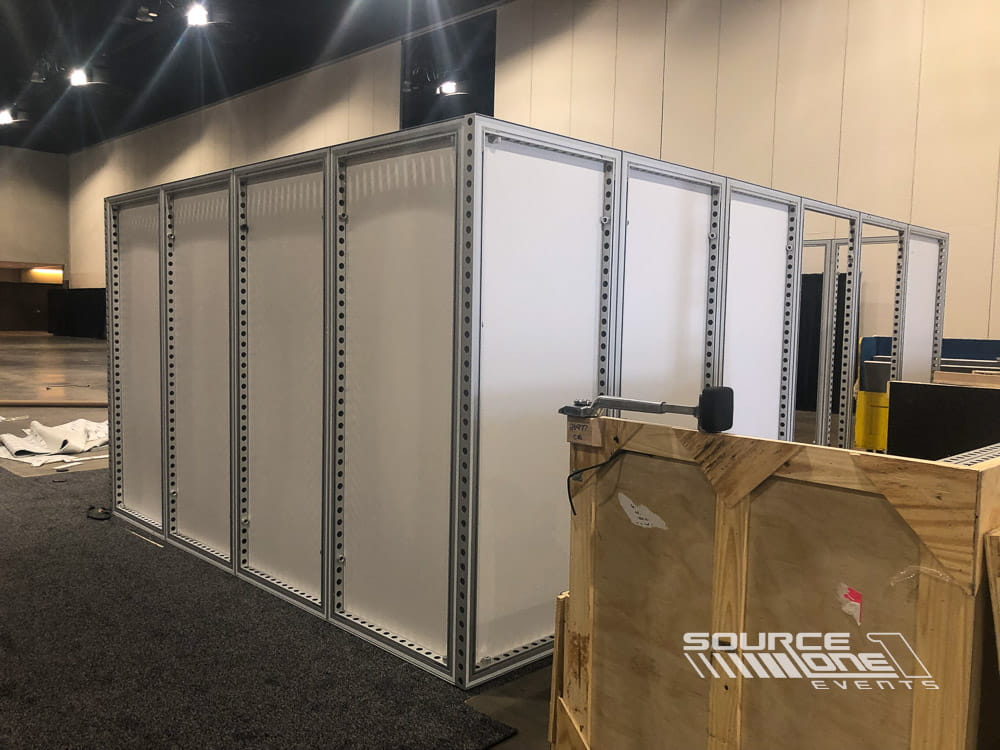Modular exhibit room system with enclosed meeting spaces, white wall panels, and professional event infrastructure.