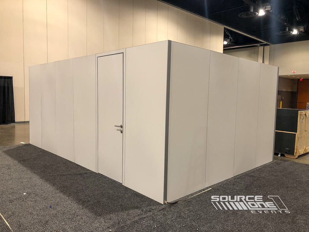 Contemporary temporary meeting room built with modular hard walls, neutral finishes, and lockable entry door.