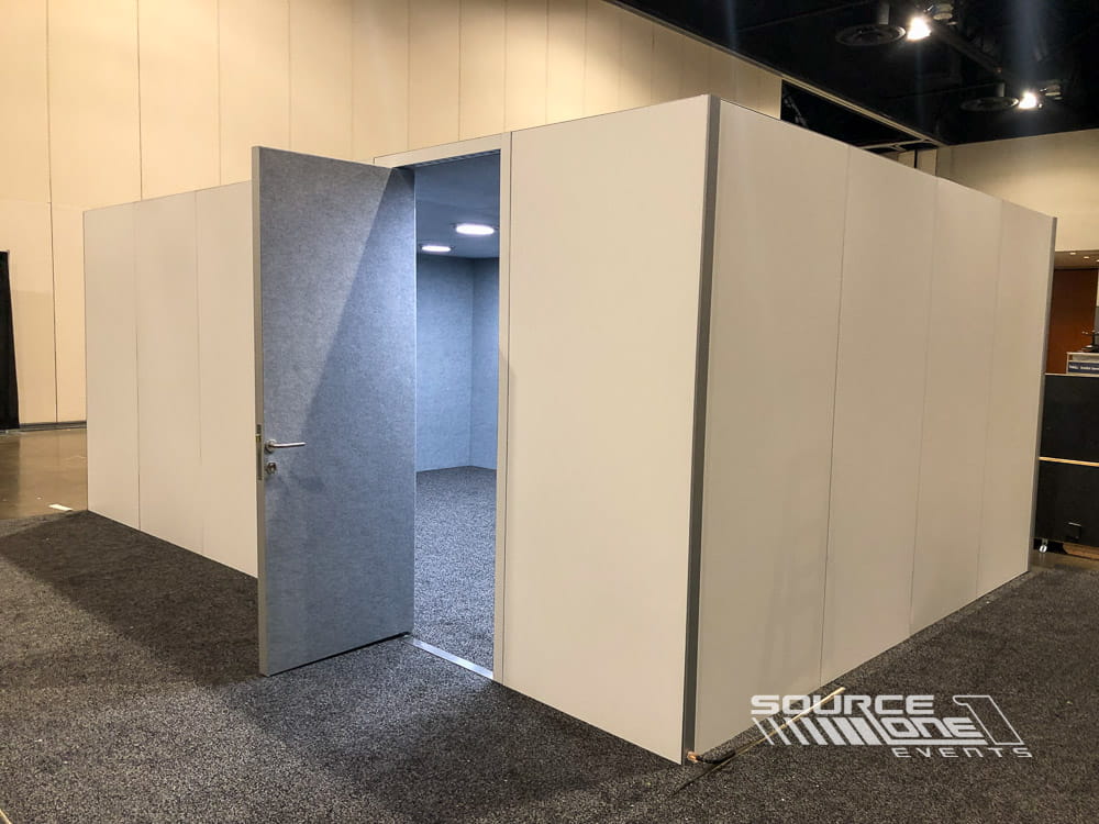 Large enclosed modular meeting room with white hard-wall construction designed for conference breakout sessions and private meetings.