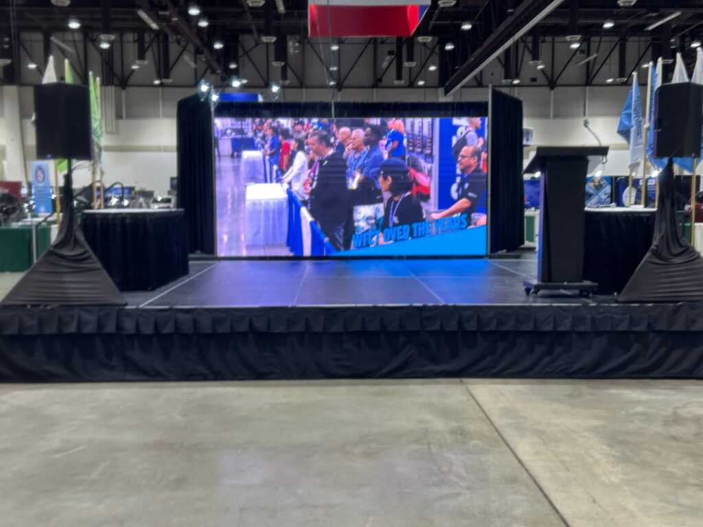 Large LED stage screen during a live conference presentation