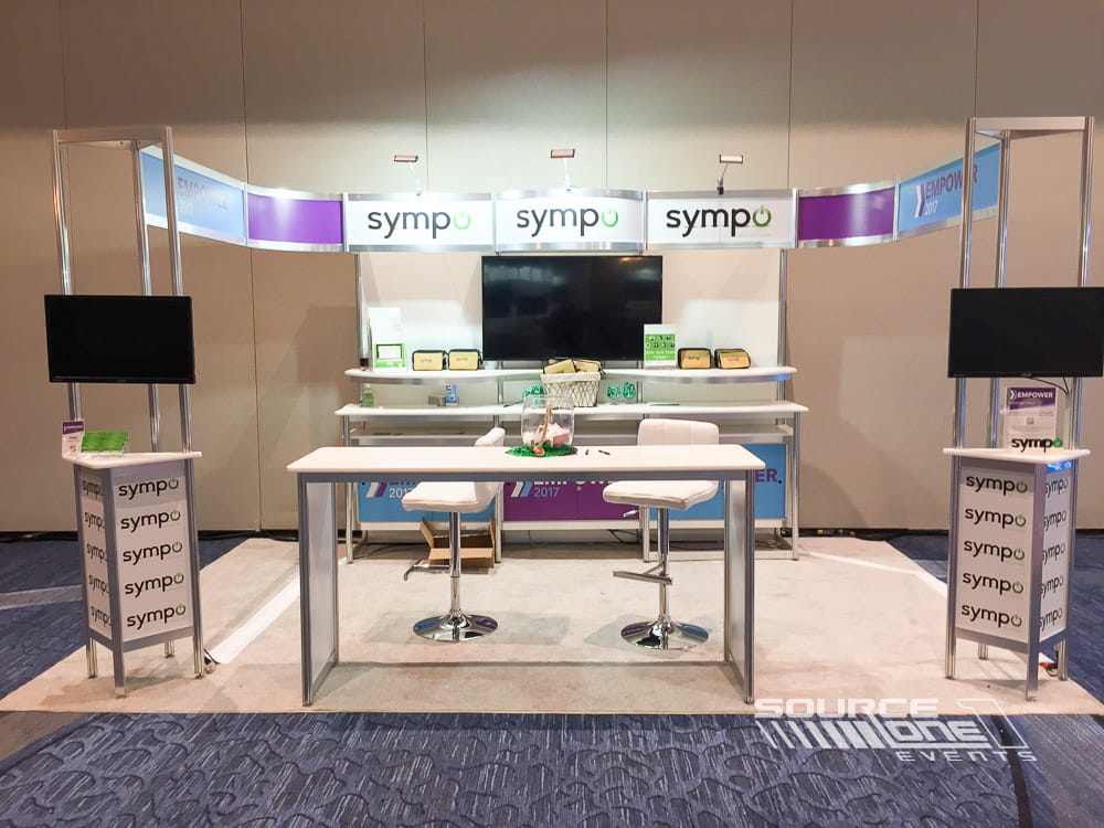 Contemporary product demonstration kiosk with clean architectural design and interactive digital engagement.