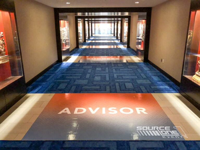 Custom carpet graphics reinforcing conference branding in a convention center corridor.