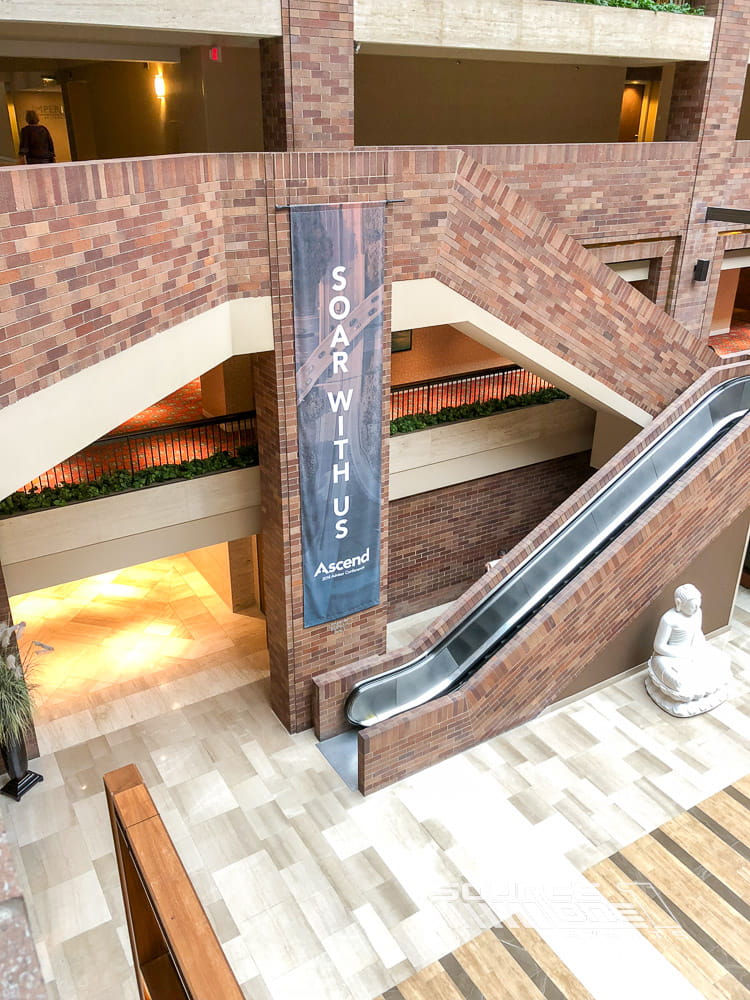 Vertical hanging fabric banner displaying Kestra branding above a conference entrance corridor.