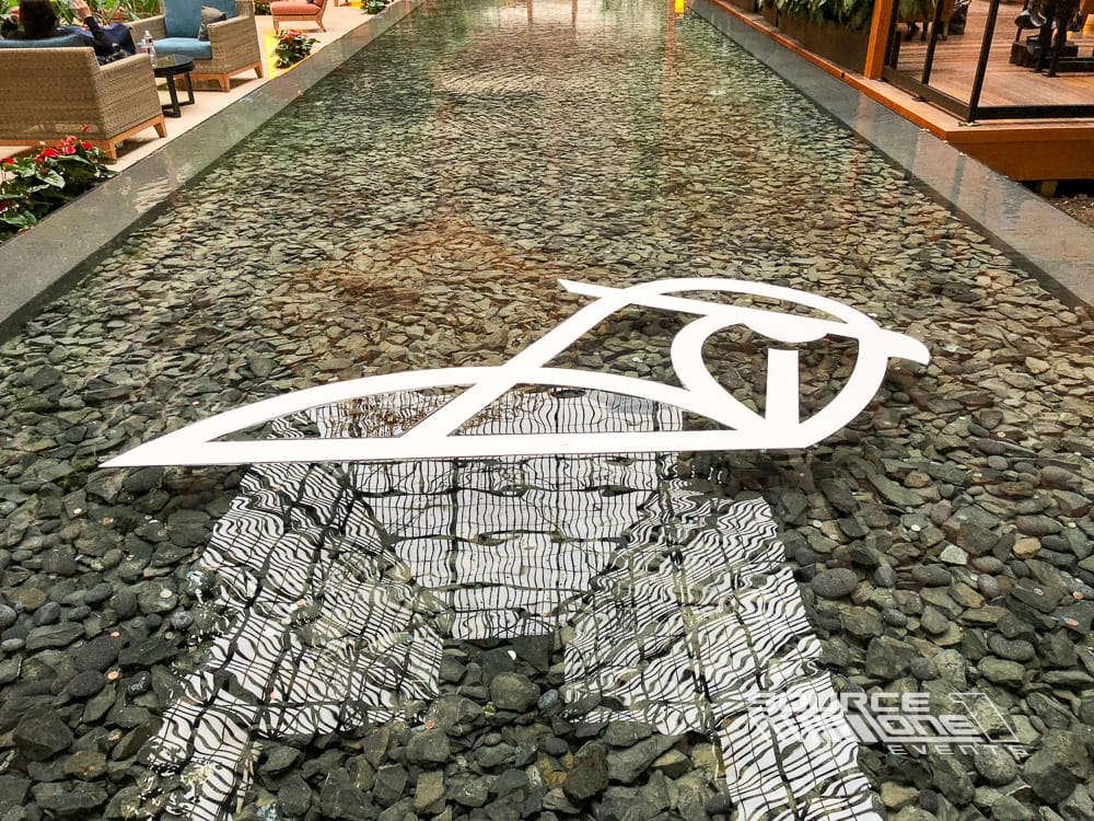 Custom lobby floor graphics and environmental branding welcoming conference attendees.