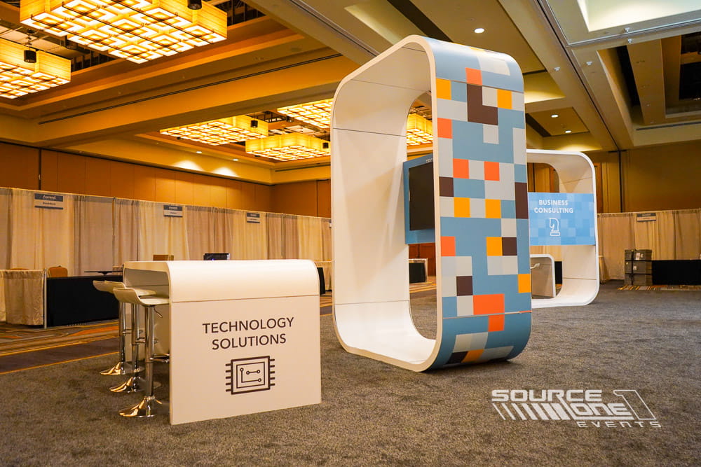 High-top collaboration table with integrated branding designed for informal attendee meetings.