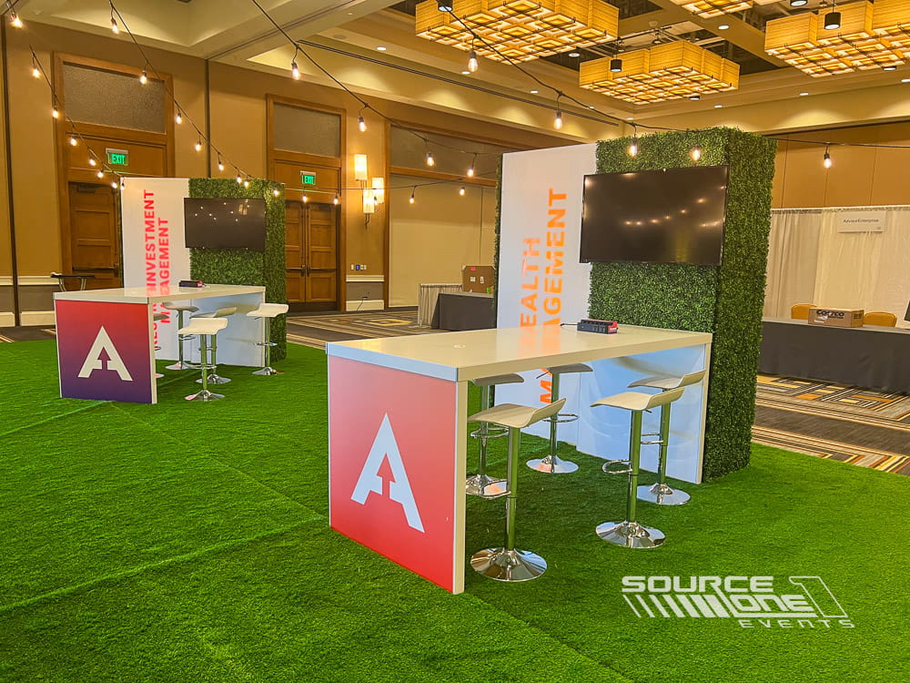 Collaborative networking area featuring branded furniture, café tables, and premium event décor.