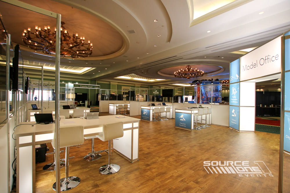 Open hospitality and workstation area with custom counters and seating for conference attendees.