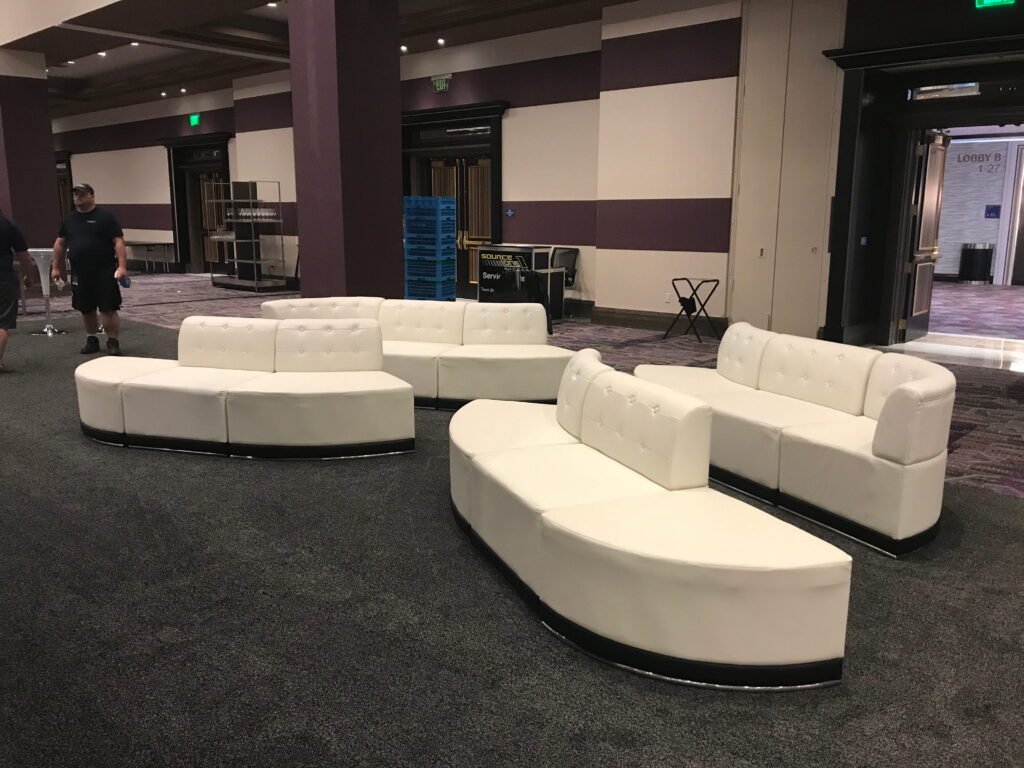 Modern curved white lounge seating rental for corporate trade show event by SourceOne
