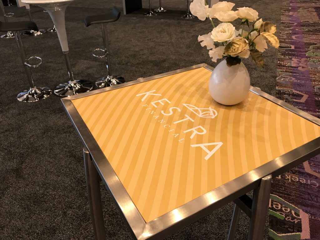 Branded tabletop display with floral centerpiece.