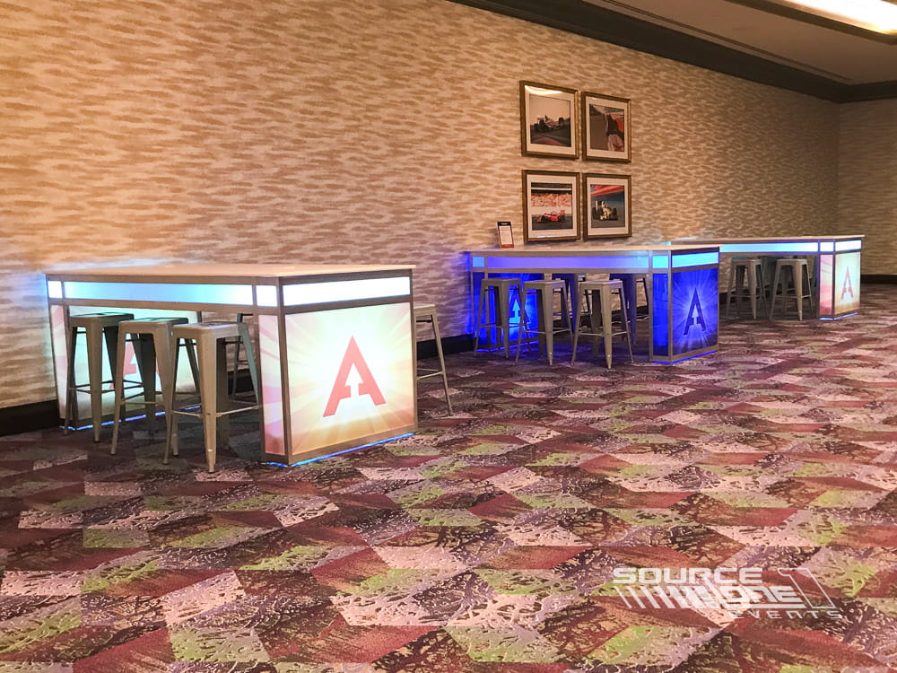 Custom branded workstation and meeting area designed for attendee consultations at a conference.