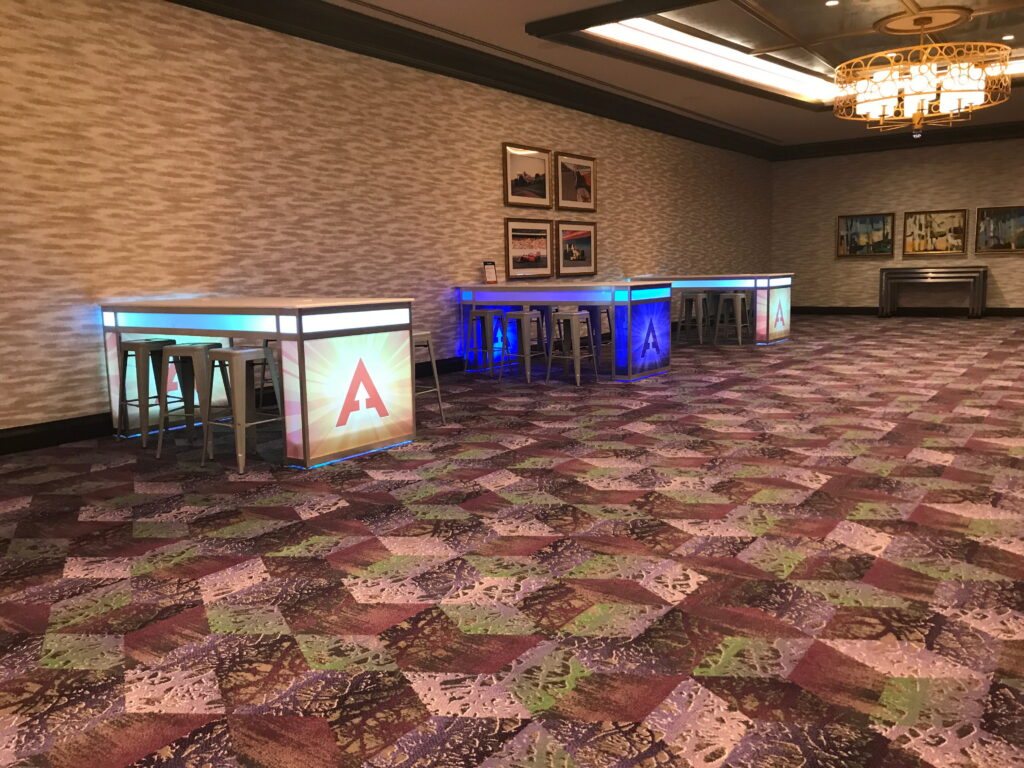 Ballroom foyer with illuminated bar and lounge setup.