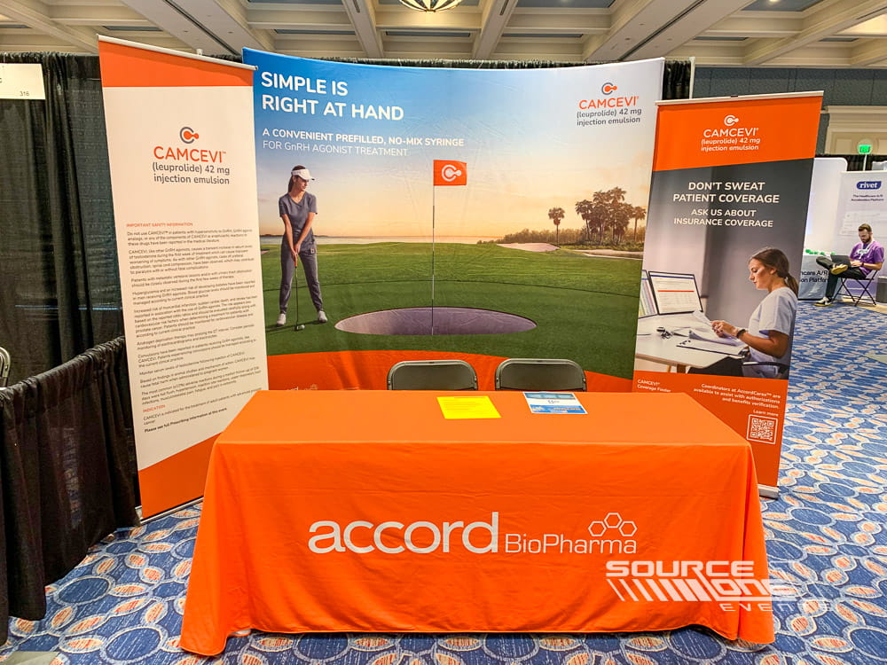 White custom table throw with colorful golf-themed branding and promotional display for exhibitor engagement at a medical conference.