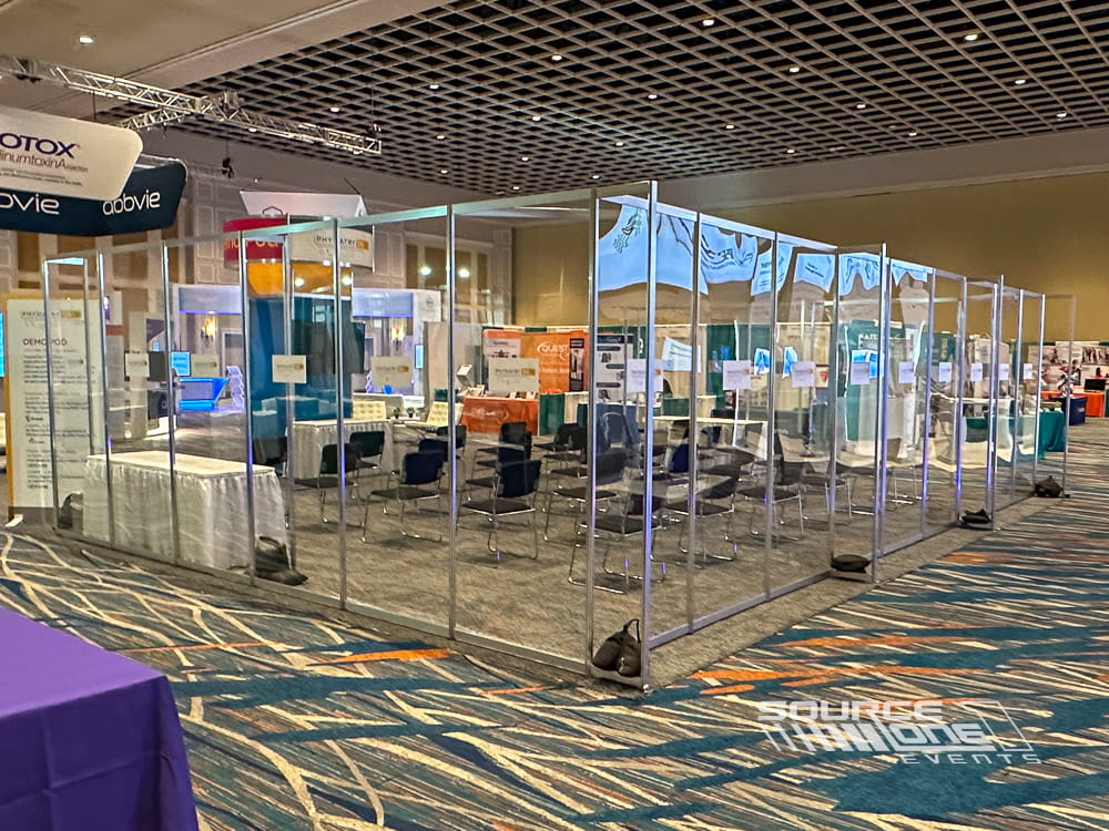 Modular hard-wall laboratory demonstration space featuring glass walls, branded graphics, and enclosed product showcase areas.
