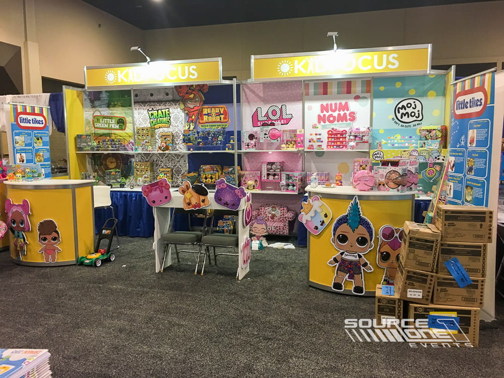 Interactive retail exhibit featuring product shelving, colorful displays, and branded shopping experience within the trade show floor.