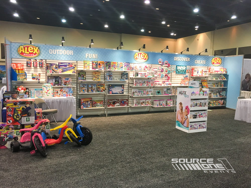 Retail-focused exhibit with organized merchandise displays, colorful branding, and engaging shopping environment for attendees.