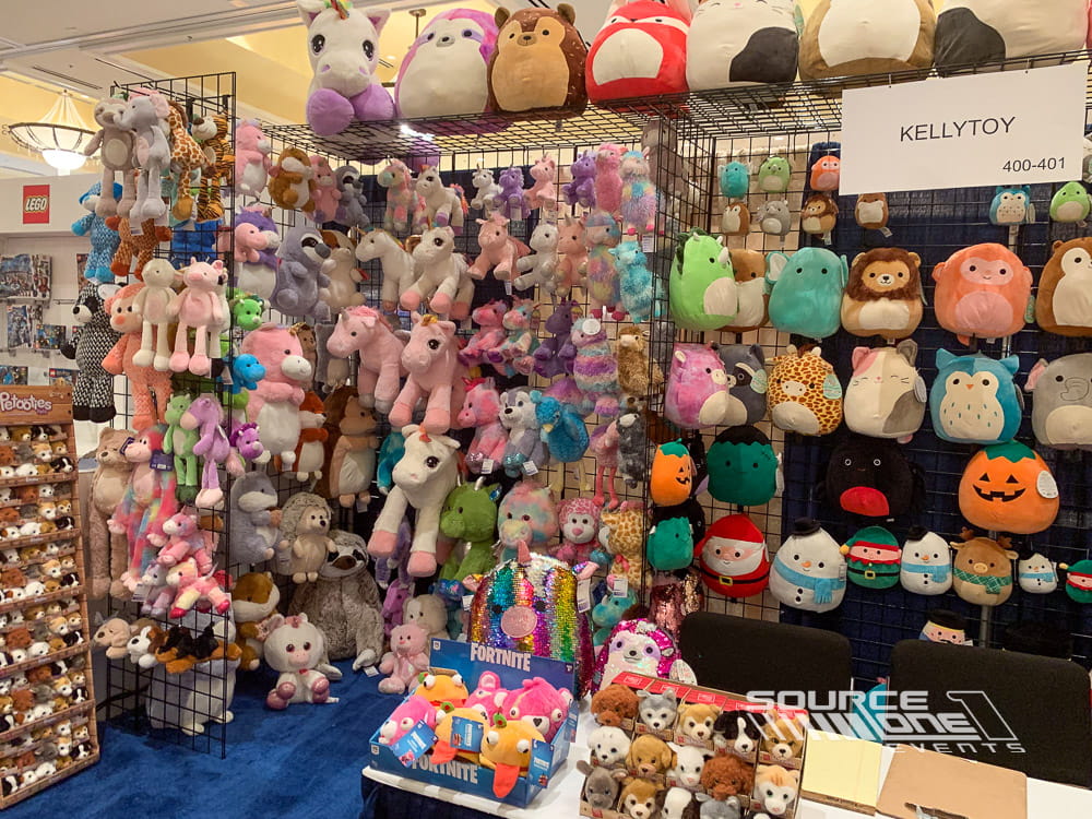 Custom retail exhibit with colorful stuffed animals displayed on organized grid wall merchandising panels.