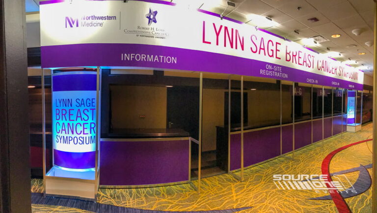 Branded registration area welcoming attendees to the Lynn Sage conference.