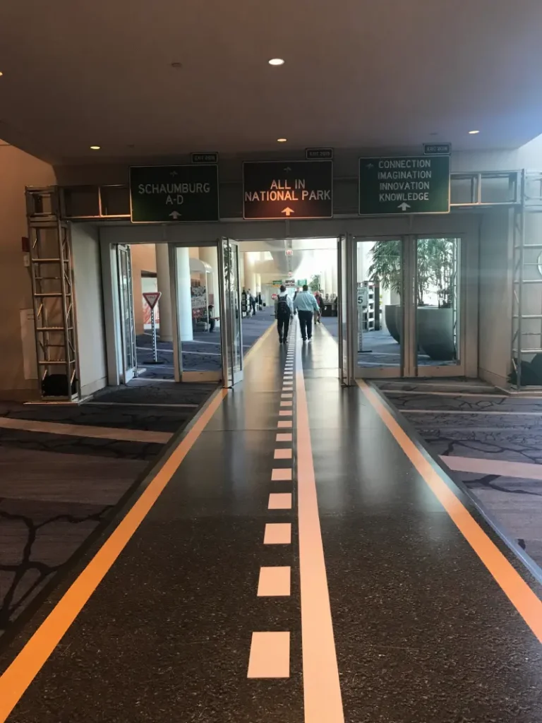 Interior corridor with road-themed flooring graphic.