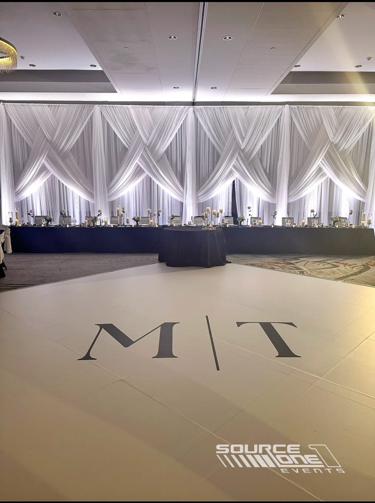 Custom branded dance floor with decorative lighting for a special event venue.