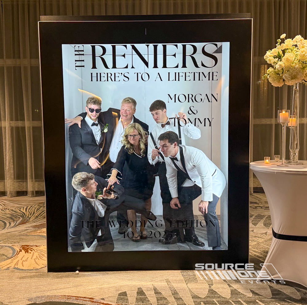 Elegant event photo booth featuring custom branded backdrop, premium lighting, and interactive guest photography experience.
