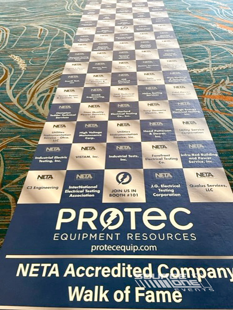 Branded floor graphics and directional wayfinding installed inside a convention center.