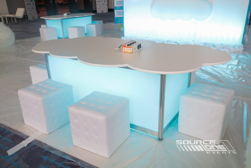 Modern custom lounge with illuminated furniture providing a comfortable networking space for event attendees.